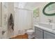 Bright bathroom featuring a skylight, modern vanity, and a shower with white curtain at 2965 Village Dr, Marietta, GA 30062