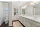 Bathroom with double sinks, bright light fixtures, and hardwood floors for a spa-like experience at 2965 Village Dr, Marietta, GA 30062