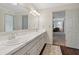 Bathroom features double sinks, a long mirror, and a view into a sitting room that enhances the interior at 2965 Village Dr, Marietta, GA 30062