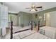 Comfortable bedroom with twin beds, a ceiling fan, and natural light from the white shuttered windows at 2965 Village Dr, Marietta, GA 30062