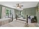 Spacious bedroom with two twin beds, bright windows, and a sitting area for relaxing or reading at 2965 Village Dr, Marietta, GA 30062