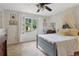 Bright bedroom with cozy decor and a large window with neighborhood views creates a warm atmosphere at 2965 Village Dr, Marietta, GA 30062