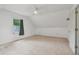 A bright bonus room featuring plush carpeting, neutral paint, and a fan for added comfort at 2965 Village Dr, Marietta, GA 30062