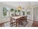 Cozy dining room with large windows, farmhouse table, and elegant lighting at 2965 Village Dr, Marietta, GA 30062