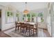 Bright dining room with a large table, many windows and an overhead decorative light fixture at 2965 Village Dr, Marietta, GA 30062