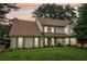 Charming two-story home with lush green lawns and foliage at 2965 Village Dr, Marietta, GA 30062