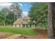 Beautiful home with lush green lawn, mature trees providing shade, and a serene front yard setting at 2965 Village Dr, Marietta, GA 30062