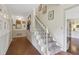 Hallway with white wainscoting, white staircase, and unique decorative artwork at 2965 Village Dr, Marietta, GA 30062