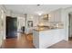 Modern kitchen with white cabinets, tile floor, granite countertops, and stainless steel appliances at 2965 Village Dr, Marietta, GA 30062
