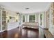 Bright living room with hardwood floors, built-in bookshelves, and scenic outdoor views at 2965 Village Dr, Marietta, GA 30062
