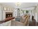 Cozy living room with a brick fireplace, hardwood floors, and ample natural light at 2965 Village Dr, Marietta, GA 30062