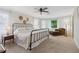 Bright main bedroom with a chaise lounge, ceiling fan, and large windows with sheer curtains at 2965 Village Dr, Marietta, GA 30062
