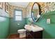 Charming powder room featuring floral wallpaper, green trim, and vintage style fixtures at 2965 Village Dr, Marietta, GA 30062