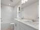 Bathroom featuring double sinks, a large mirror, a bathtub and a window at 706 Smokey Quartz Way, Kennesaw, GA 30144