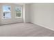 A bright bedroom with carpet, two windows, and white walls at 706 Smokey Quartz Way, Kennesaw, GA 30144