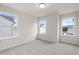 Bright bedroom featuring three windows offering natural light and neighborhood views at 706 Smokey Quartz Way, Kennesaw, GA 30144