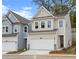 Charming two-story home featuring a white garage door, complemented by stone accents at 706 Smokey Quartz Way, Kennesaw, GA 30144
