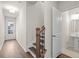Hallway with wood floors, a staircase, and a view of a powder room at 706 Smokey Quartz Way, Kennesaw, GA 30144