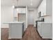 Well-lit kitchen featuring white cabinets, stainless appliances, and a center island at 706 Smokey Quartz Way, Kennesaw, GA 30144