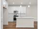 Modern kitchen featuring white cabinets, stainless steel appliances, and an island at 706 Smokey Quartz Way, Kennesaw, GA 30144