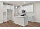 Modern kitchen featuring white cabinets, stainless steel appliances, and an island at 706 Smokey Quartz Way, Kennesaw, GA 30144