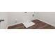 A bright laundry room featuring wood floors and white baseboards and walls at 706 Smokey Quartz Way, Kennesaw, GA 30144