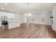 Open-concept living space with wood floors, a kitchen, and a fireplace at 706 Smokey Quartz Way, Kennesaw, GA 30144