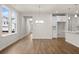 Open-concept living space with wood floors, a kitchen, and a view of the entryway at 706 Smokey Quartz Way, Kennesaw, GA 30144