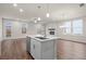 Open-concept living space showcasing a kitchen island, living room, and abundant natural light at 706 Smokey Quartz Way, Kennesaw, GA 30144