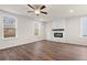 Bright living room with a modern fireplace, ceiling fan, and large windows at 706 Smokey Quartz Way, Kennesaw, GA 30144