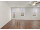 Airy living room featuring large windows, neutral paint, and hardwood flooring at 706 Smokey Quartz Way, Kennesaw, GA 30144