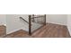 Interior staircase featuring wood treads, black metal spindles, and wood railing at 706 Smokey Quartz Way, Kennesaw, GA 30144
