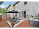 Inviting backyard patio featuring a dining set, black umbrella, and view of the house's exterior at 146 Sunset Ln, Woodstock, GA 30189
