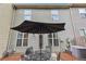 Backyard patio with an outdoor seating arrangement and privacy fence and the view of upper windows at 146 Sunset Ln, Woodstock, GA 30189