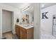 Bathroom with double sink vanity, decorative mirror, and access to another room at 146 Sunset Ln, Woodstock, GA 30189
