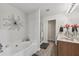 Bright bathroom featuring a soaking tub, glass enclosed shower, and vanity with sink at 146 Sunset Ln, Woodstock, GA 30189