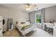 Bright bedroom features a white bed frame, a desk, a ceiling fan, and natural light at 146 Sunset Ln, Woodstock, GA 30189