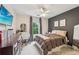 Bedroom featuring a dark accent wall, a desk, and a window with natural light at 146 Sunset Ln, Woodstock, GA 30189