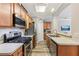 Galley kitchen with stainless steel appliances, wood cabinets, and light countertops at 146 Sunset Ln, Woodstock, GA 30189