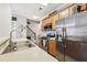 Modern kitchen featuring stainless steel appliances, wood cabinets, and sleek countertops at 146 Sunset Ln, Woodstock, GA 30189