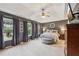 Spacious main bedroom with tray ceiling, dark walls, and large windows with dark drapes at 146 Sunset Ln, Woodstock, GA 30189