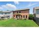 Grassy backyard with mature trees and a pergola-covered patio provides ample space for outdoor enjoyment at 2532 Gloster Mill Drive Southwest, Lawrenceville, GA 30044