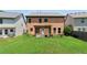 Expansive backyard with lush green lawn and a charming pergola-covered patio, perfect for outdoor entertaining at 2532 Gloster Mill Drive Southwest, Lawrenceville, GA 30044