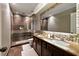 Luxurious bathroom with custom tile work, a double vanity, and a frameless glass shower at 2532 Gloster Mill Drive Southwest, Lawrenceville, GA 30044