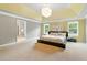 Spacious main bedroom featuring tray ceilings, neutral walls, and large windows for a bright and airy ambiance at 2532 Gloster Mill Drive Southwest, Lawrenceville, GA 30044