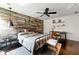 Stylish bedroom featuring a wood accent wall, desk space, and industrial-chic lighting at 2532 Gloster Mill Drive Southwest, Lawrenceville, GA 30044