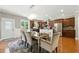 Dining area adjacent to kitchen featuring a modern table, stainless steel refrigerator, and outdoor access at 2532 Gloster Mill Drive Southwest, Lawrenceville, GA 30044