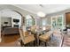 Open-concept dining area featuring a modern table, with seamless flow into the living area and kitchen at 2532 Gloster Mill Drive Southwest, Lawrenceville, GA 30044