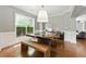 Dining area with a modern light fixture, hardwood floors, and a large window, perfect for a bright, airy feel at 2532 Gloster Mill Drive Southwest, Lawrenceville, GA 30044