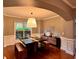 Elegant dining room featuring a unique dining table with bench seating and stylish decor at 2532 Gloster Mill Drive Southwest, Lawrenceville, GA 30044